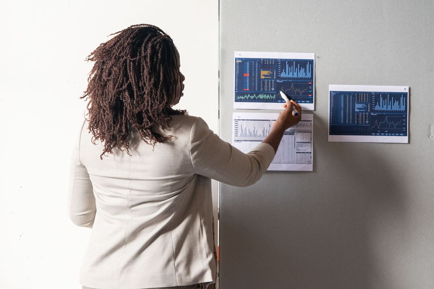 A person pointing to a specific data point on a chart during a meeting - nonprofit fundraising performance metrics A person pointing to a specific data point on a chart during a meeting - nonprofit fundraising performance metrics